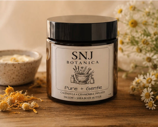 Jar of SNJ Botanica product on a wooden surface with flowers and a bowl in the background