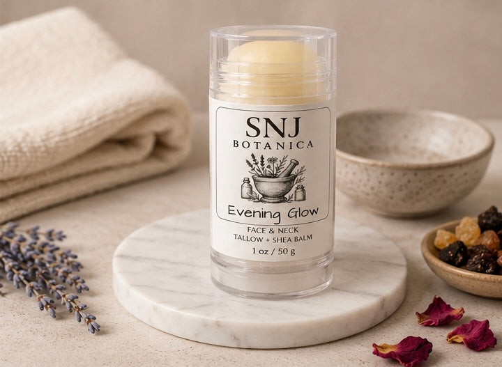 Balm stick with 'SNJ Botanica' label on a marble coaster with natural elements.