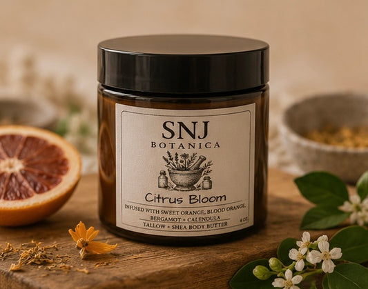 Jar of SNJ Botanica Citrus Bloom on a wooden surface with botanical elements.