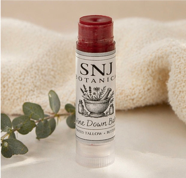 Lip balm with 'SNJ Botanical' label on a neutral background