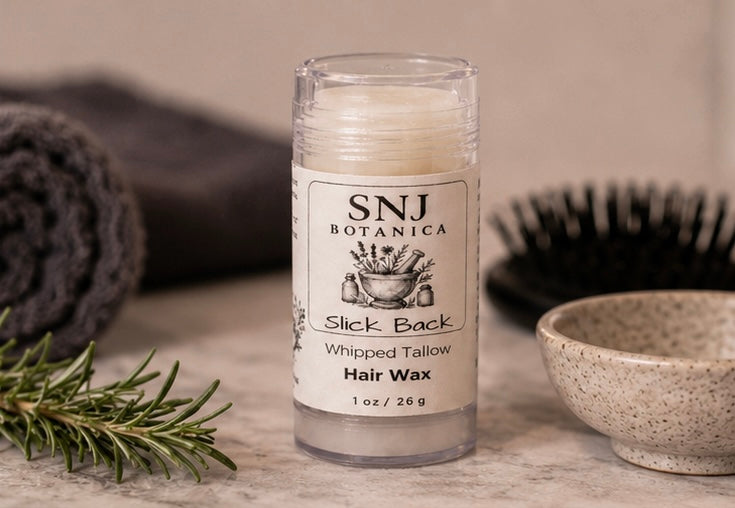 Hair wax stick with 'SNJ Botanica' label on a wooden surface with natural elements.