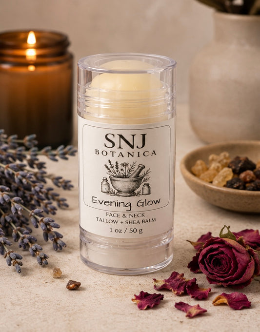 Balm stick with 'SNJ Botanica Evening Glow' label on a rustic background with lavender and roses.