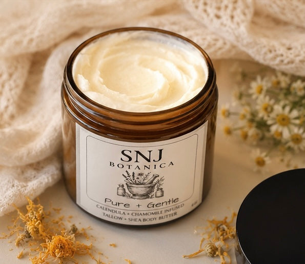 Jar of SNJ Botanica body butter with a soft background