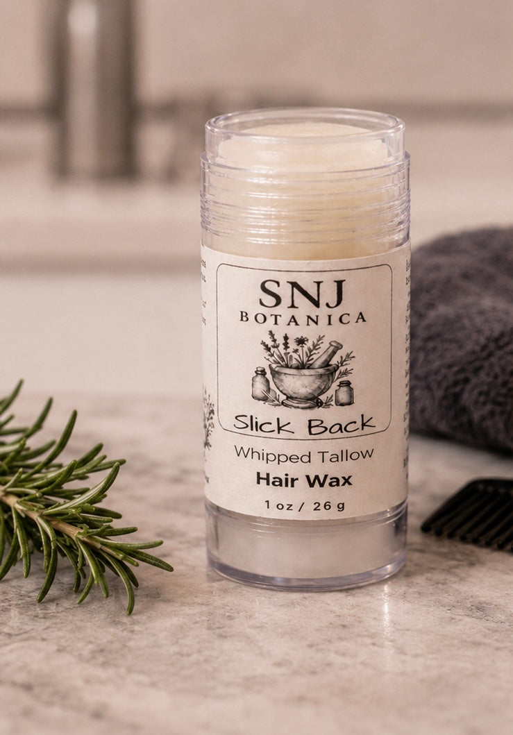 Hair wax stick with SNJ Botanica label on a countertop with a branch and towel in the background