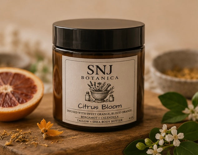 Jar of SNJ Botanica Citrus Bloom on a wooden surface with botanical elements.