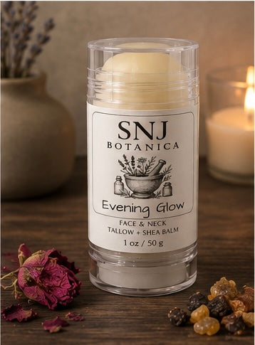 Balm stick with 'SNJ Botanica' label on a wooden surface with natural elements.