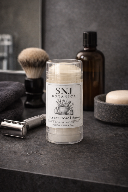 Bottle of SNJ Botanica Forest Beard Balm on a dark surface with grooming items.