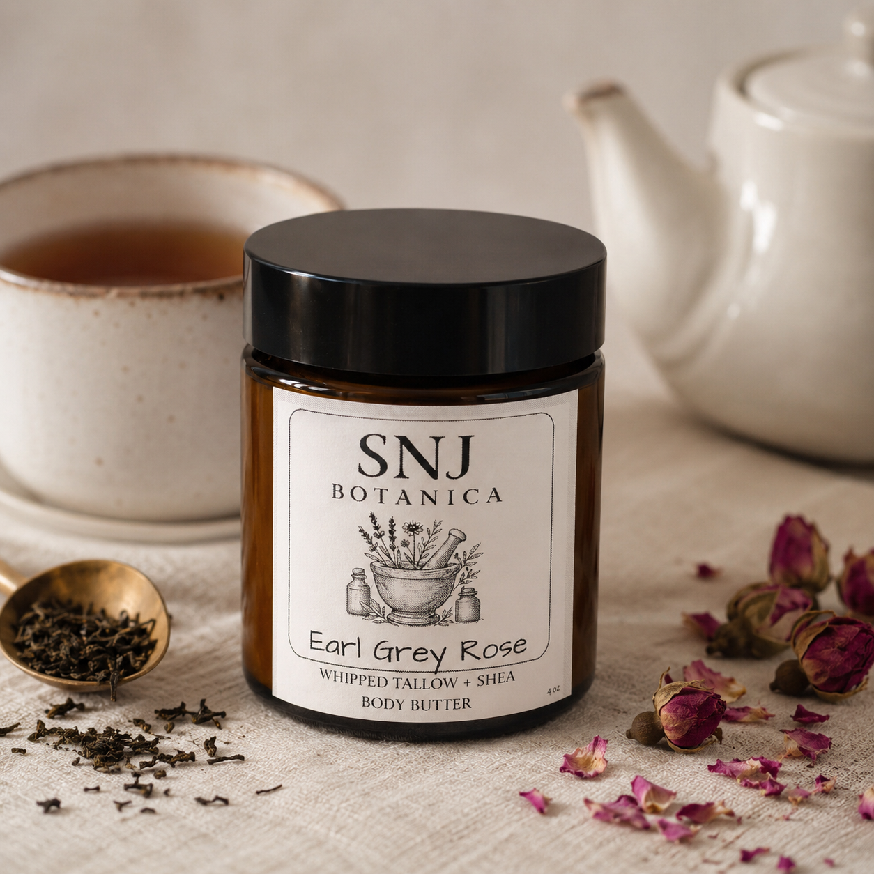 Jar of SNJ Botanica Earl Grey Rose body butter with tea cup and teapot in the background