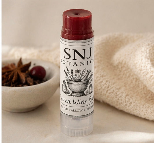 Lip balm with 'SNJ Botanics' label on a neutral background